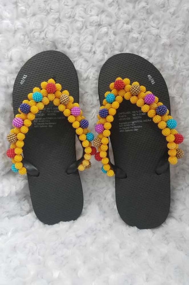 The colorful beads bring grace and joy to the pair of black slippers