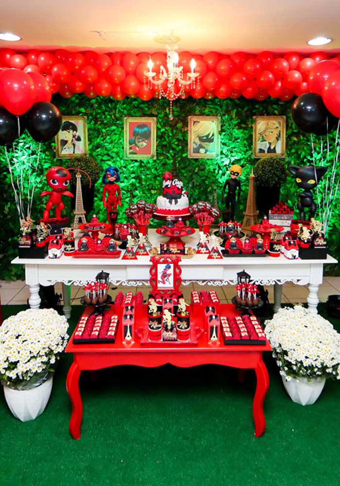 Cake table decoration for Ladybug party. Red, black and green tones stand out