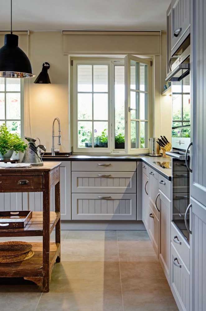 In this Provencal kitchen, the gray cabinets got moldings on the doors and an old and worn wooden cabinet was used for the island.