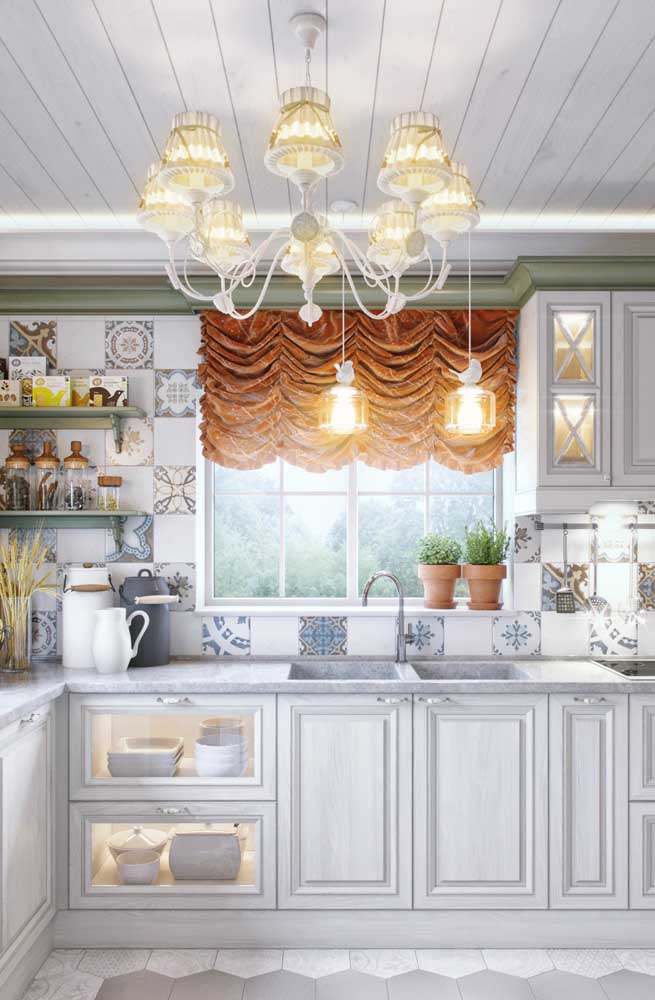 In this Provencal kitchen, it is the curtain and chandelier that draw all the attention