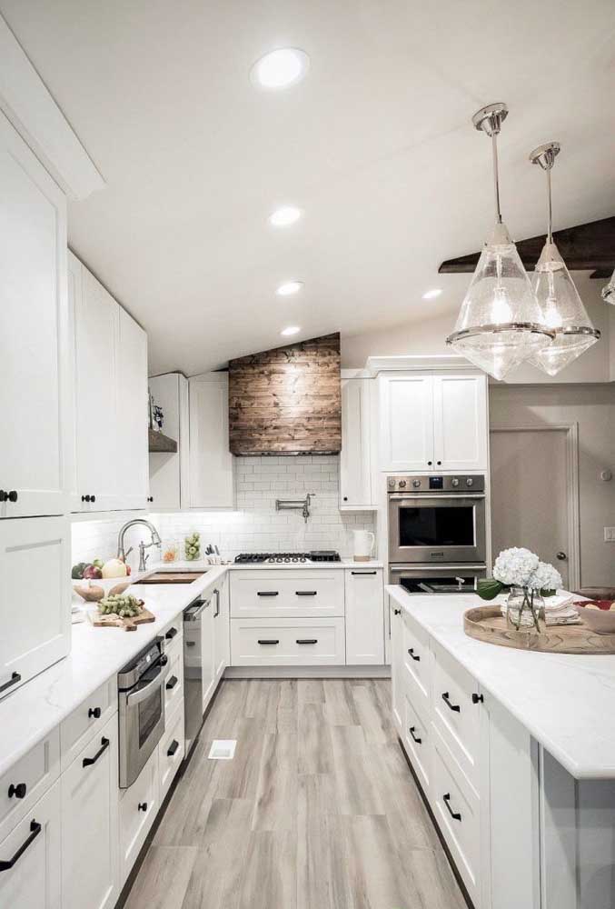 A huge Provencal kitchen and all white. Notice the contrast that the black handles bring to the environment