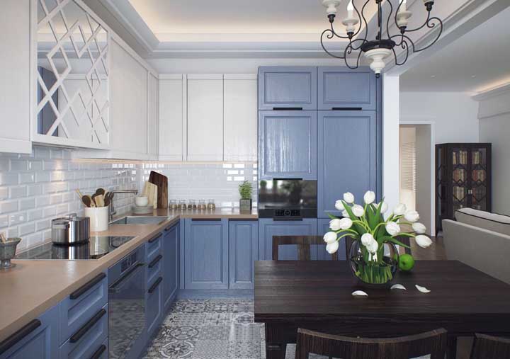 Provencal kitchen with illuminated plaster molding, blue cabinets and dark wooden table. Create your project according to your tastes and needs