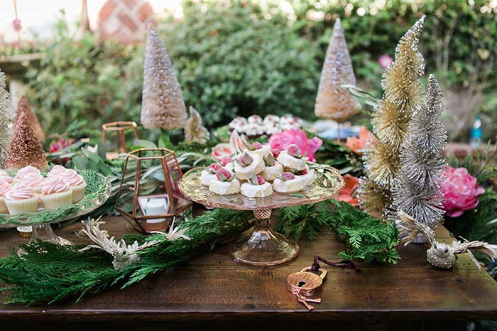 Mix natural tree branches and store-bought Christmas trees for enchanted kingdom decor