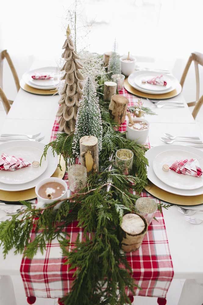 Here, the table decoration is practically all pine! Under it, a checkered band to compose the colors of Christmas