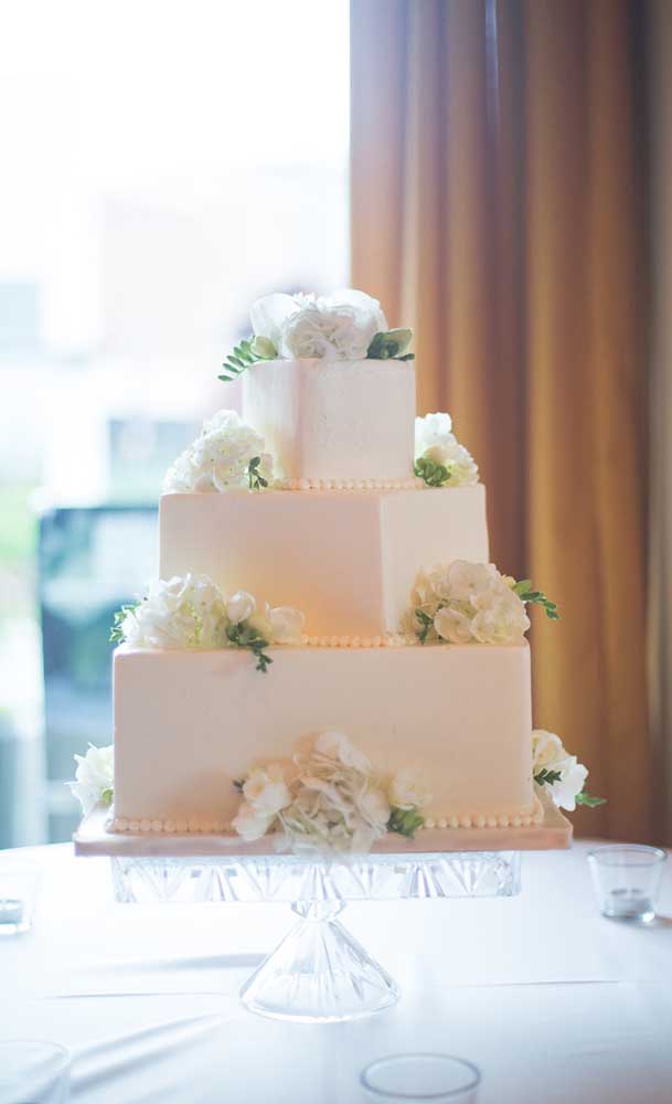 Square fake cake with three floors for a wedding. You need to get very close to notice that the cake is not really