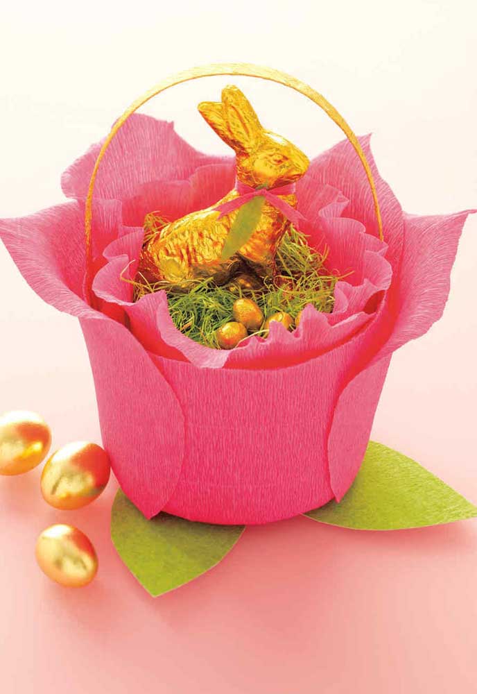 Small Easter basket made with crepe paper, inside rabbit and chocolate eggs