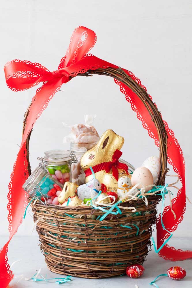 Wicker Easter basket with chocolates and chocolate rabbits