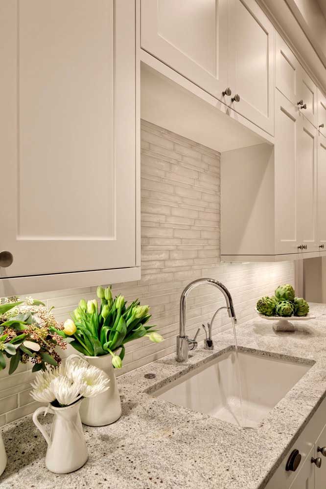 Class and elegance in this white kitchen with gray granite countertops
