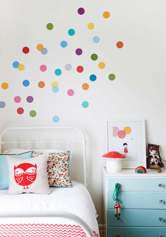 Small details: colorful circular stickers on the wall decor of the girl's room