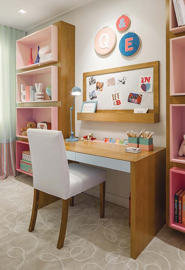 Girl's room decor with desk and pink shelves