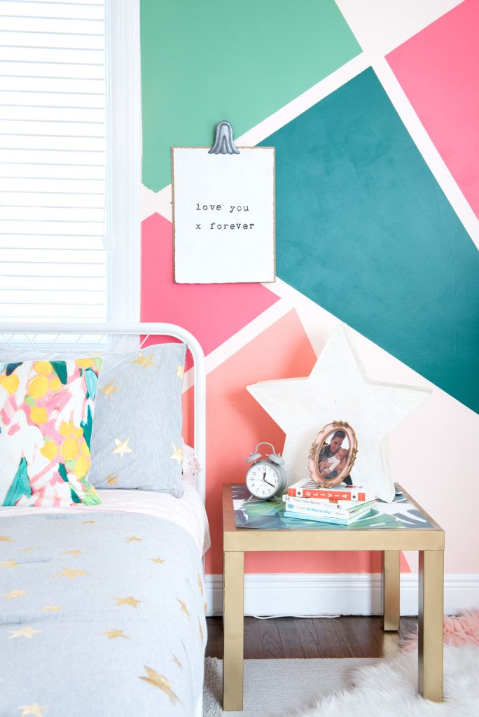 Geometric shapes and flashy colors in this girl's bedroom wallpaper