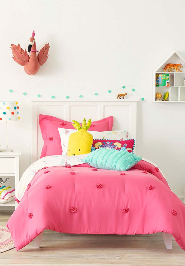 Neutral girl's room where colorful bedding draws attention