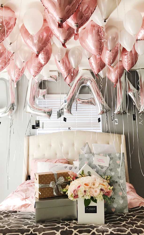 Surprise for boyfriend with balloons and gifts in decorated room 