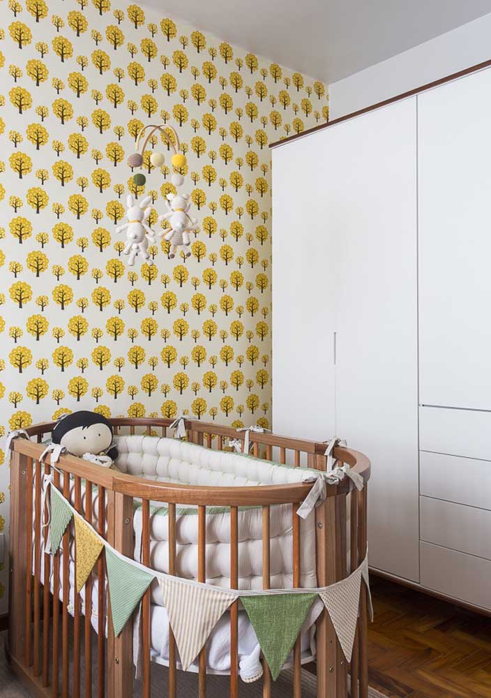 The round wooden crib is a charm only in this masculine baby room design