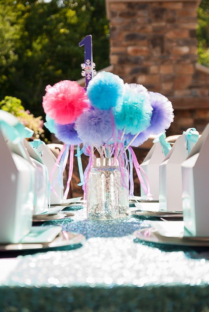 Table arrangement with tulle pompoms on a stick.