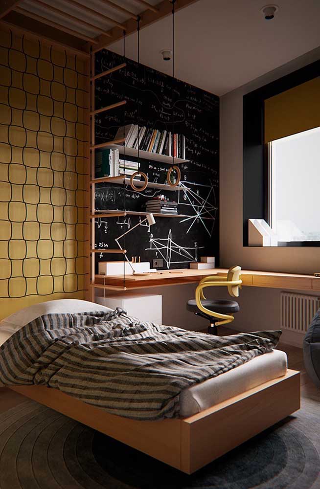 Small single room decorated in yellow and black tones. To compensate for dark tones, a very large window