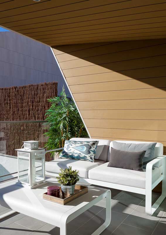 White sofa for sunbathed balcony