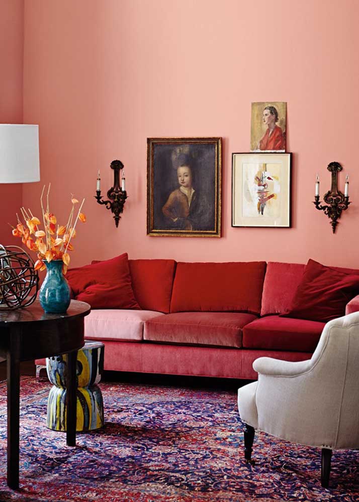 Living room with red and velvet sofa. Want more? So paint the wall pink!