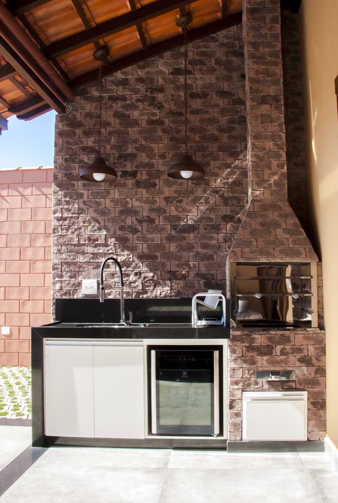 Brick barbecue in covered area with sink and minibar; note that the same brick used on the barbecue also covers the wall