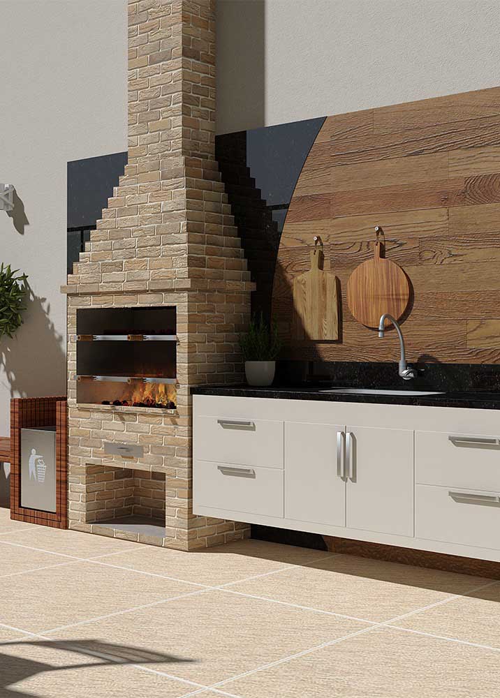 In this gourmet space, the simple brick barbecue in a traditional model shares the attention with the wooden panel