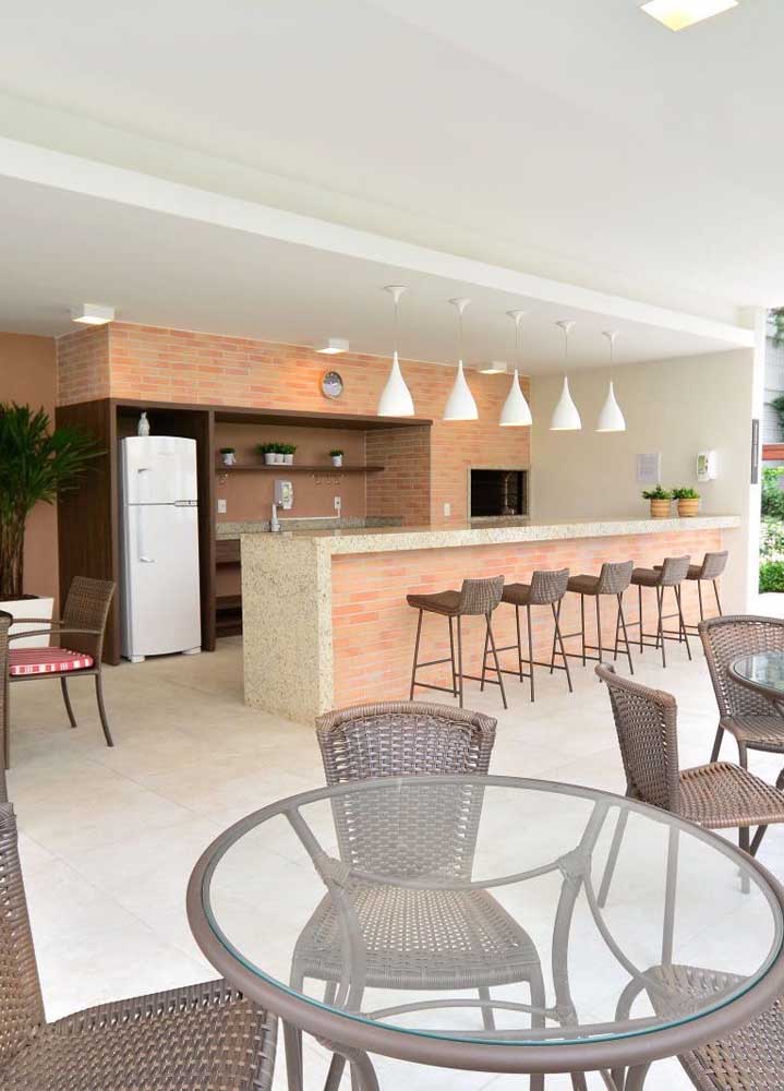 Large barbecue area with counter, tables and exposed brick barbecue