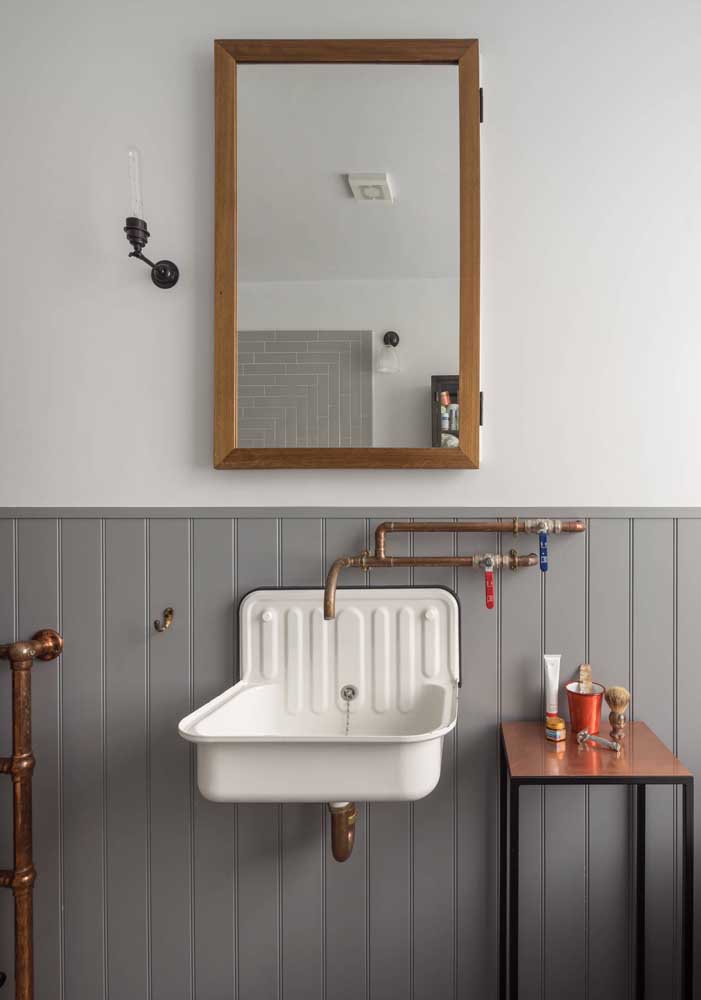 The small copper-topped table perfectly matched the details of the exposed plumbing in this bathroom