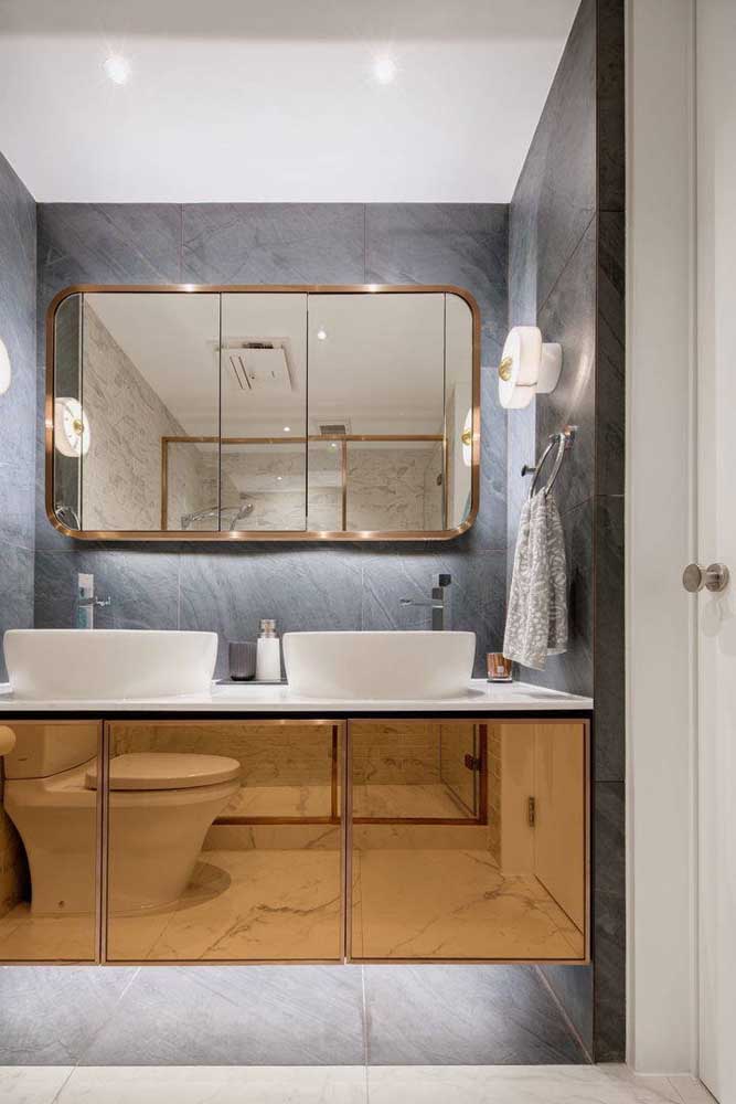 This bathroom has a copper-framed mirror and an incredible mirrored cabinet 