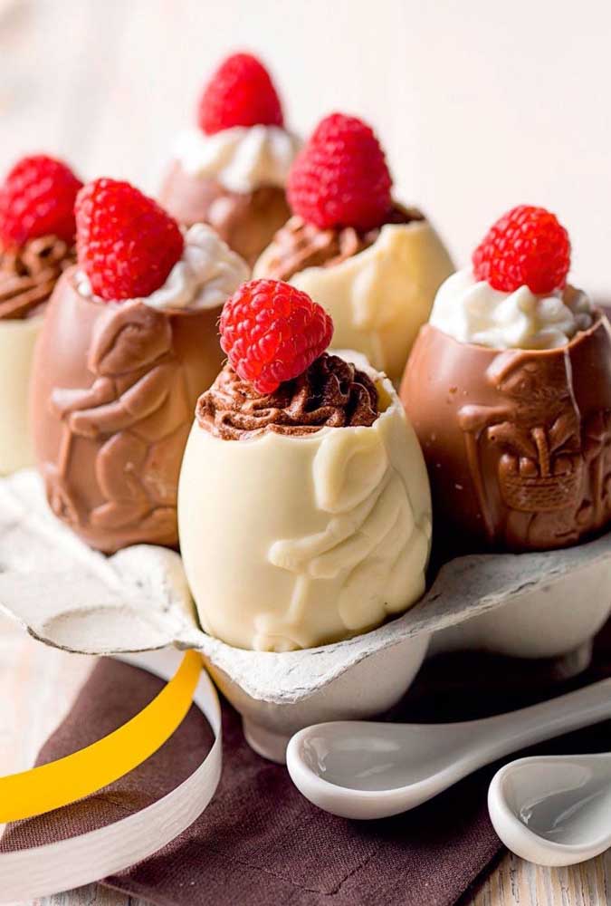 Easter eggs filled with chocolate with red fruits; notice that the egg brings the cute cartoon of bunnies riding a bicycle