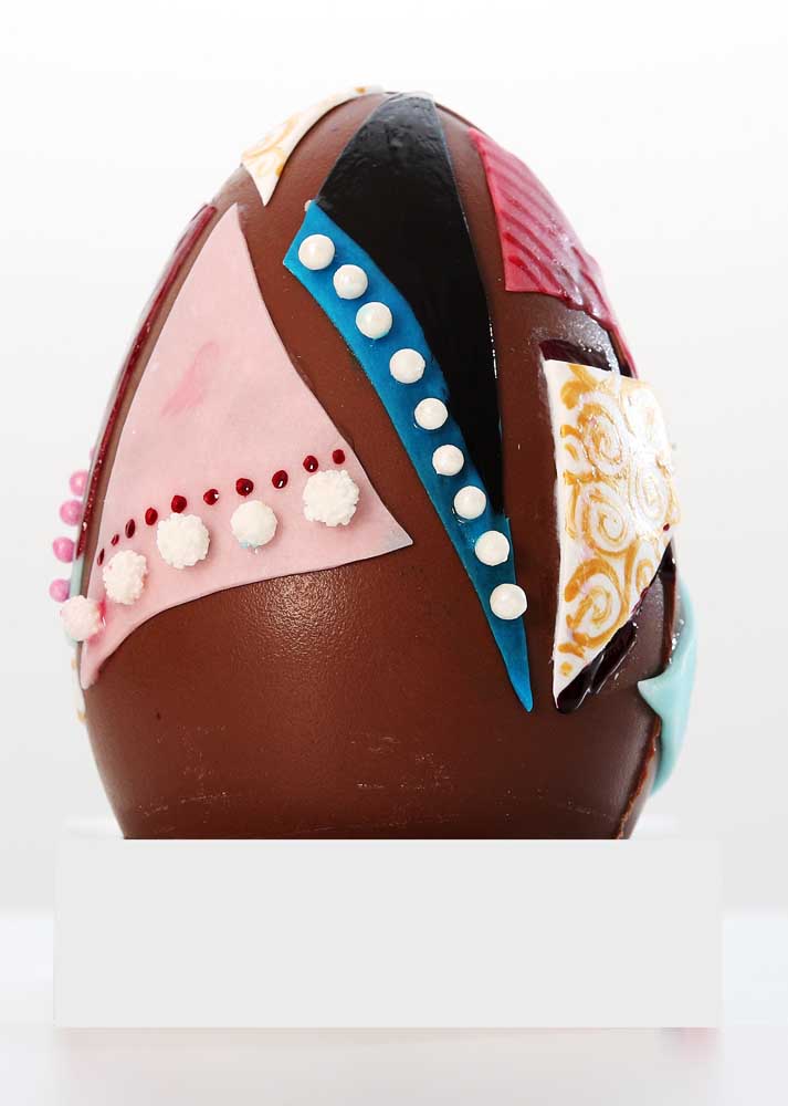 Easter egg decorated with colorful chocolate strips