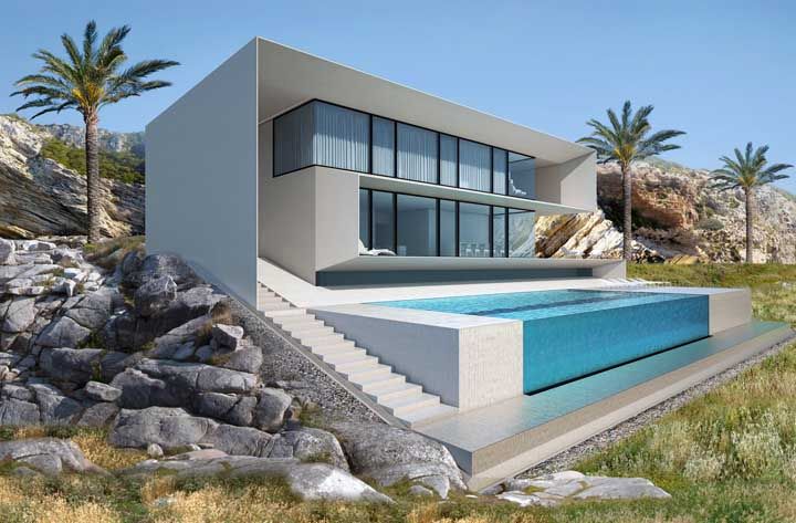 The contemporary house makes a beautiful contrast to the natural landscape, not to mention the glass pool that takes away everyone's heart