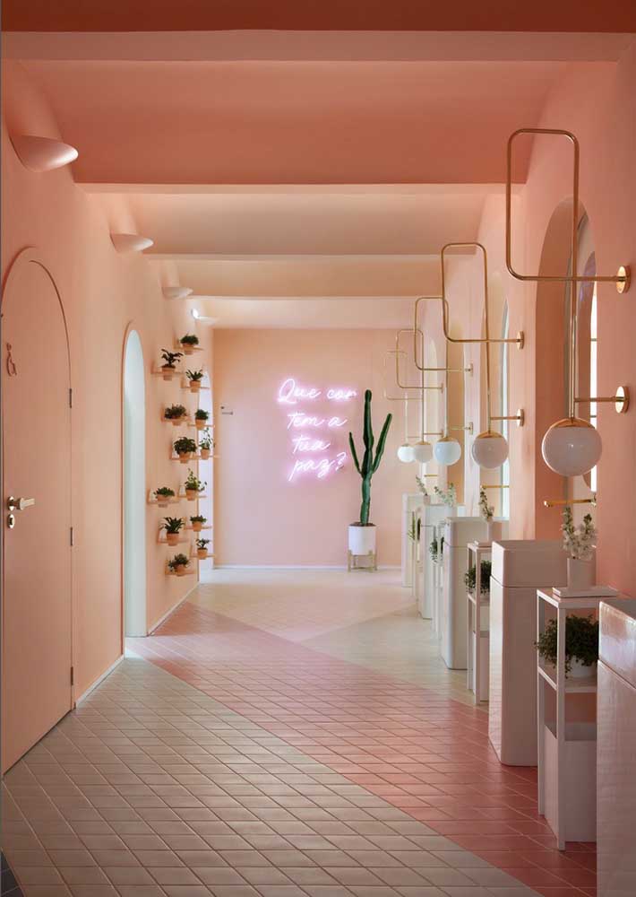 The long pink corridor has a neon sign right in the back