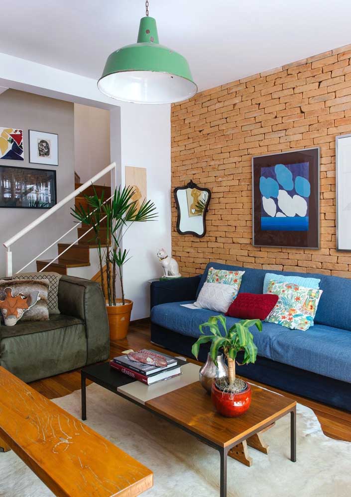 Royal blue sofa to match the room's brick wall
