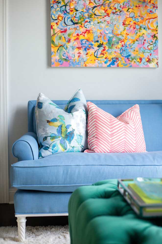 Light blue sofa with patterned pillows for colorful living room