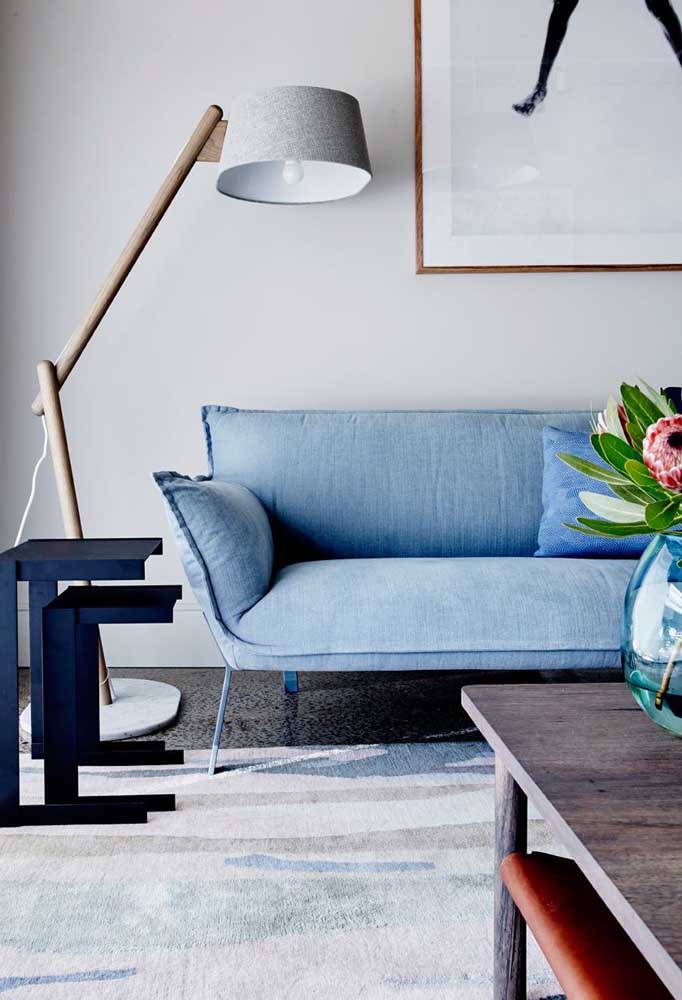 Modern space with light blue sofa opposite gray wood-based lamp