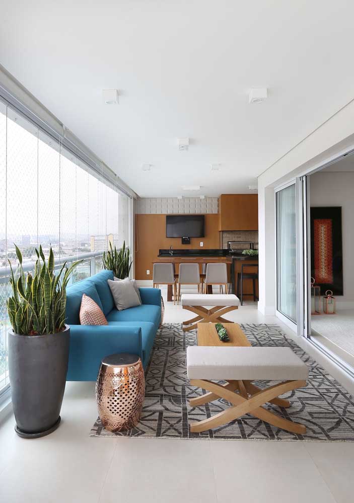 Integrated living room with blue sofa matching contemporary pieces