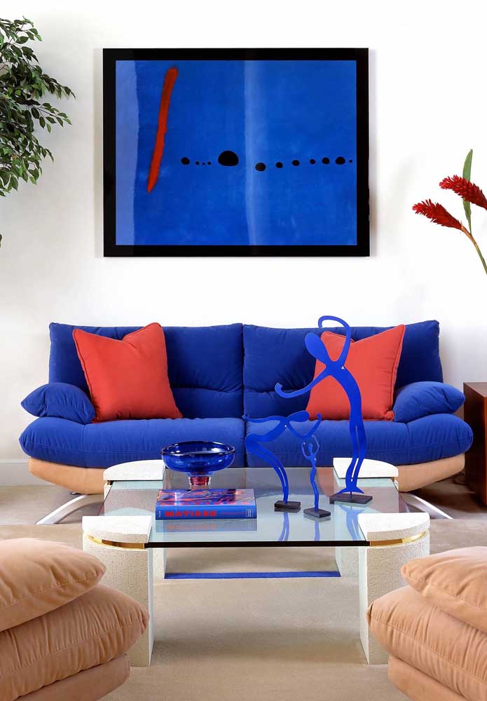 This sofa is the highlight of the living room; the shade of blue was perfect in contrast to the orange hue of the pillows, the frame and the flowers
