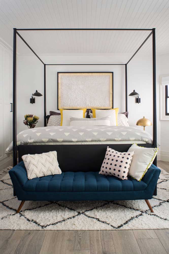 The oil blue velvet recamier positioned next to the couple's bed is the highlight of this environment