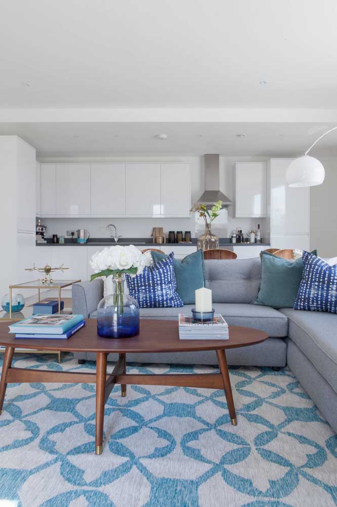 Clean and very inviting environment with light blue sofa and pillows in different shades of blue