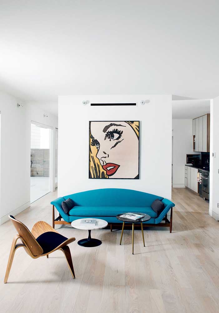 Turquoise blue sofa for the contemporary living room; notice the strong contrast created with the white of the walls