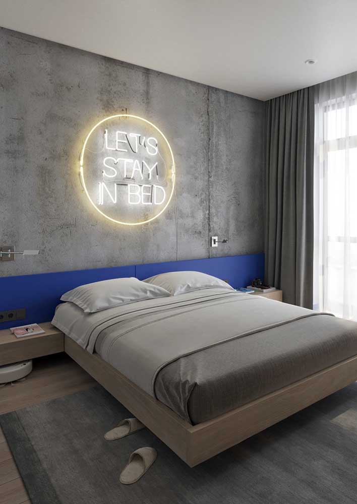 Modern double bedroom with neon sign on the burnt cement wall