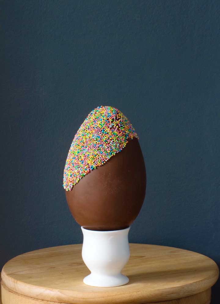 Half and half: Easter egg decorated with colorful sprinkles 